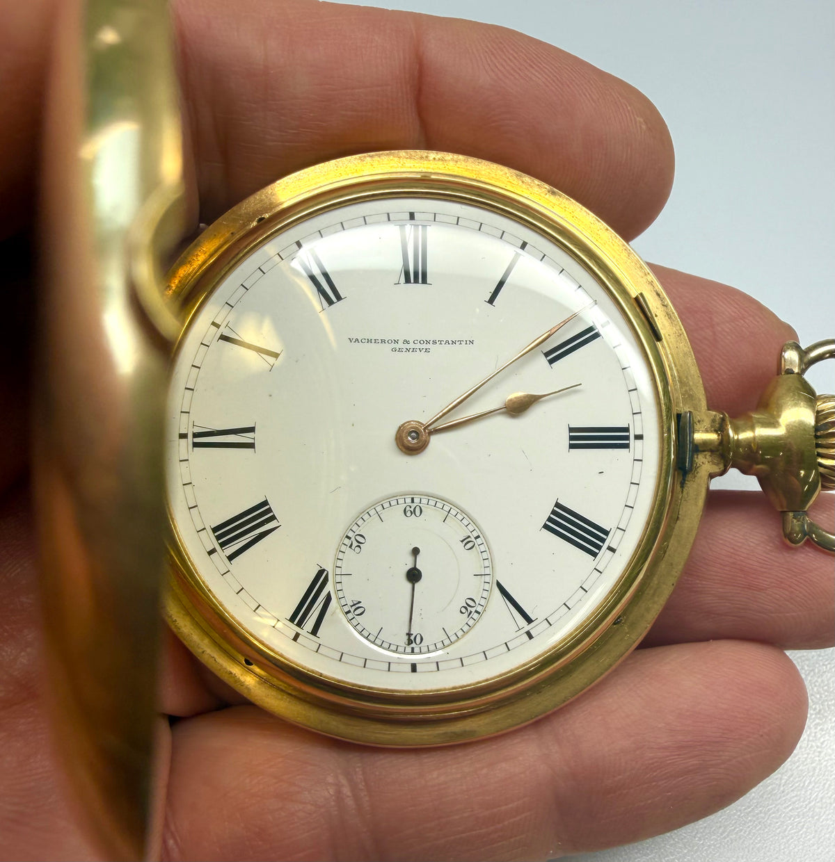 Pocket watch with Roman numerals and an open gold-colored cover