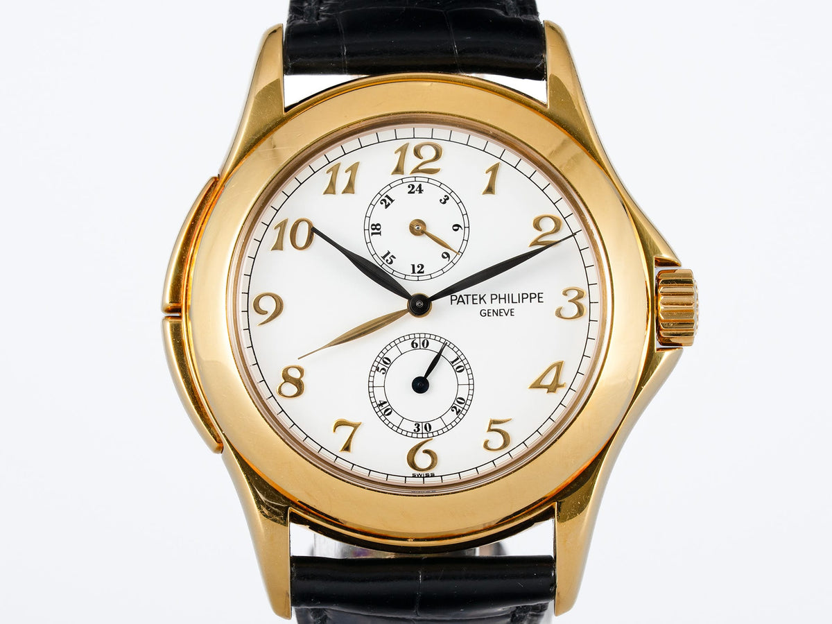 Wrist watch with a white dial, gold-colored case, and black leather strap